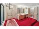 Retro pink bathroom with a sunken tub, pink fixtures, and a unique chandelier at 3416 Ocotea St, Raleigh, NC 27607