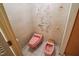 Tiled pink toilet and bidet with floral wallpaper at 3416 Ocotea St, Raleigh, NC 27607