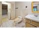 Bathroom featuring an outdated toilet, sink and tiling at 3416 Ocotea St, Raleigh, NC 27607