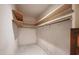 Walk-in closet with wooden shelves and unique geometric tile floor at 3416 Ocotea St, Raleigh, NC 27607
