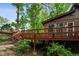 Exterior view of a wood deck with stairs leading to a lush, wooded yard at 3416 Ocotea St, Raleigh, NC 27607