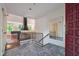 A tiled foyer with a black metal banister and a view into a living room area with a fireplace at 3416 Ocotea St, Raleigh, NC 27607