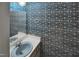 Powder room featuring unique blue and white patterned wallpaper and light blue sink at 3416 Ocotea St, Raleigh, NC 27607