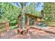 Charming back deck with ample seating that wraps around a mature tree creating a cozy and inviting outdoor space at 36 Birnamwood Dr, Chapel Hill, NC 27516