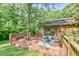 Enjoy this back deck with an outdoor seating area with views of the surrounding lush green lawn and mature shade trees at 36 Birnamwood Dr, Chapel Hill, NC 27516