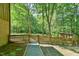 Backyard featuring wooded area and fenced in yard with gravel path at 36 Birnamwood Dr, Chapel Hill, NC 27516