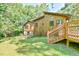 Exterior rear of home with a deck and sprawling yard with mature trees, perfect for outdoor activities at 36 Birnamwood Dr, Chapel Hill, NC 27516