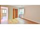 Bedroom featuring hardwood floors, bi-fold closet, and backyard views at 36 Birnamwood Dr, Chapel Hill, NC 27516