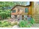 Rear exterior with wood facade, brick foundation, and brick patio area at 36 Birnamwood Dr, Chapel Hill, NC 27516