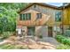 Rear exterior with wood facade, brick foundation, and brick patio area at 36 Birnamwood Dr, Chapel Hill, NC 27516