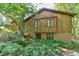 Exterior view of house with wood facade and brick foundation at 36 Birnamwood Dr, Chapel Hill, NC 27516