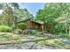 Exterior view of house with wood facade, surrounded by mature trees at 36 Birnamwood Dr, Chapel Hill, NC 27516