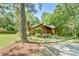 Wood-sided single-Gathering home with an angled roof and well-manicured landscaping with trees at 36 Birnamwood Dr, Chapel Hill, NC 27516