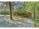 Wood-sided single-Gathering home with well-manicured landscaping and gravel driveway at 36 Birnamwood Dr, Chapel Hill, NC 27516