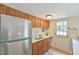 Cozy kitchen featuring stainless steel refrigerator, white subway tile, and backyard access at 36 Birnamwood Dr, Chapel Hill, NC 27516