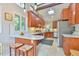 Well-equipped kitchen with wooden cabinets, modern appliances, and unique stained glass window accents at 36 Birnamwood Dr, Chapel Hill, NC 27516