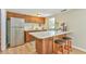 Kitchen featuring stainless steel refrigerator, white backsplash, and bar top seating at 36 Birnamwood Dr, Chapel Hill, NC 27516
