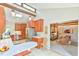 Modern kitchen leading to a living room with exposed wooden beams and cozy seating at 36 Birnamwood Dr, Chapel Hill, NC 27516