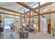 Bright living room featuring exposed wooden beams, skylights, comfortable seating, and an open layout at 36 Birnamwood Dr, Chapel Hill, NC 27516