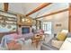 Charming living room with exposed wooden beams, brick fireplace, and cozy seating area at 36 Birnamwood Dr, Chapel Hill, NC 27516
