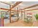 Open-concept living and dining area boasting hardwood floors, exposed beams, and a cozy fireplace at 36 Birnamwood Dr, Chapel Hill, NC 27516