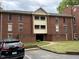 Brick apartment building with balconies and walkway entrance at 3601 Helix Ct # 301, Raleigh, NC 27606