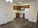 Bright kitchen with white appliances and wood cabinets at 3601 Helix Ct # 301, Raleigh, NC 27606