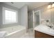 Well-lit bathroom with a glass-enclosed shower, tub, and a double vanity at 3684 Ben Mil Ct, Franklinton, NC 27525