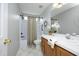 Neutral bathroom with a shower-tub combo, white tile surround, and a wood vanity with a white countertop at 3684 Ben Mil Ct, Franklinton, NC 27525