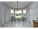 Bright breakfast nook featuring a chandelier, windows with backyard views, and space for seating at 3684 Ben Mil Ct, Franklinton, NC 27525