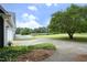 Spacious driveway featuring lush greenery and a charming white picket fence bordering the property at 3684 Ben Mil Ct, Franklinton, NC 27525