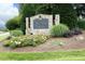 Community entrance sign surrounded by manicured landscaping and lush greenery at 3684 Ben Mil Ct, Franklinton, NC 27525