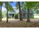 Charming exterior showcasing lush, mature trees, well-manicured lawn, and a meticulously maintained home at 3684 Ben Mil Ct, Franklinton, NC 27525