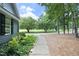Landscaped walkway leading to the home's entrance with lush greenery and mature trees at 3684 Ben Mil Ct, Franklinton, NC 27525