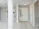 Bright foyer featuring neutral walls, a chandelier, columns, and an exterior door with sidelights at 3684 Ben Mil Ct, Franklinton, NC 27525