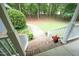 Inviting front porch with brick steps, white railings, and a view of the wooded front yard at 3684 Ben Mil Ct, Franklinton, NC 27525