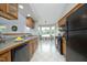 Bright kitchen featuring oak cabinets, modern black appliances, and a sunny breakfast nook with garden views at 3684 Ben Mil Ct, Franklinton, NC 27525