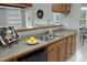 Well-lit kitchen featuring oak cabinets, modern appliances, and a breakfast bar for easy entertaining at 3684 Ben Mil Ct, Franklinton, NC 27525