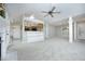 Open-concept living space with neutral walls, carpeted floors, columns, and partial kitchen view at 3684 Ben Mil Ct, Franklinton, NC 27525