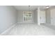 Versatile living space with neutral walls, carpeted floors, columns, and window with shutters at 3684 Ben Mil Ct, Franklinton, NC 27525