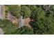 Aerial view of a house surrounded by lush green trees, showcasing its secluded and peaceful setting at 4038 Redwood Rd, Durham, NC 27704