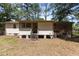 Backyard view of a home featuring a screened-in porch and wood siding at 4038 Redwood Rd, Durham, NC 27704