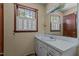 Bathroom with a sink, mirror, and a window providing natural light at 4038 Redwood Rd, Durham, NC 27704