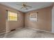 Bedroom with carpet, ceiling fan, and windows providing natural light at 4038 Redwood Rd, Durham, NC 27704