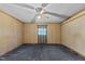 Bedroom features paneled walls, plush carpet, and a window with curtains at 4038 Redwood Rd, Durham, NC 27704