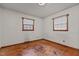 A bedroom with hardwood flooring and two windows allowing natural light at 4038 Redwood Rd, Durham, NC 27704
