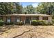 Charming single-story brick home featuring green shutters and a well-maintained front yard at 4038 Redwood Rd, Durham, NC 27704