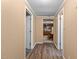 Hallway with plank flooring and multiple doorways at 4038 Redwood Rd, Durham, NC 27704
