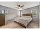 Neutral bedroom featuring a ceiling fan and light filled windows at 4524 Sugar Maple Rd, Oxford, NC 27565