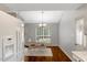 Bright dining area with a modern light fixture, hardwood floors, and a view of the backyard at 4524 Sugar Maple Rd, Oxford, NC 27565